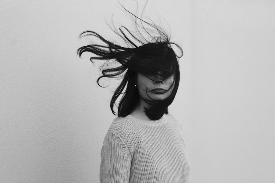 Expressive portrait with hair swept across the face